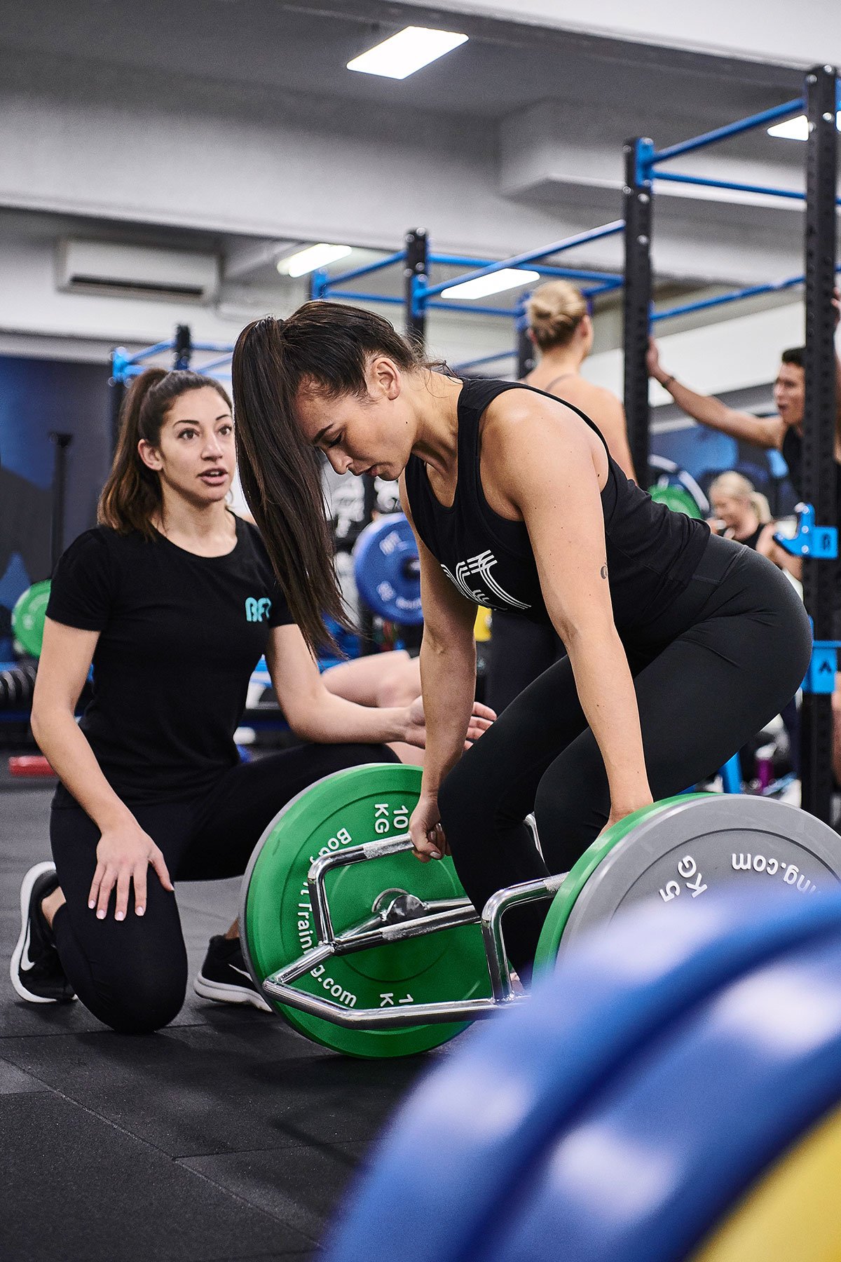 BFT instructor guiding person weight training